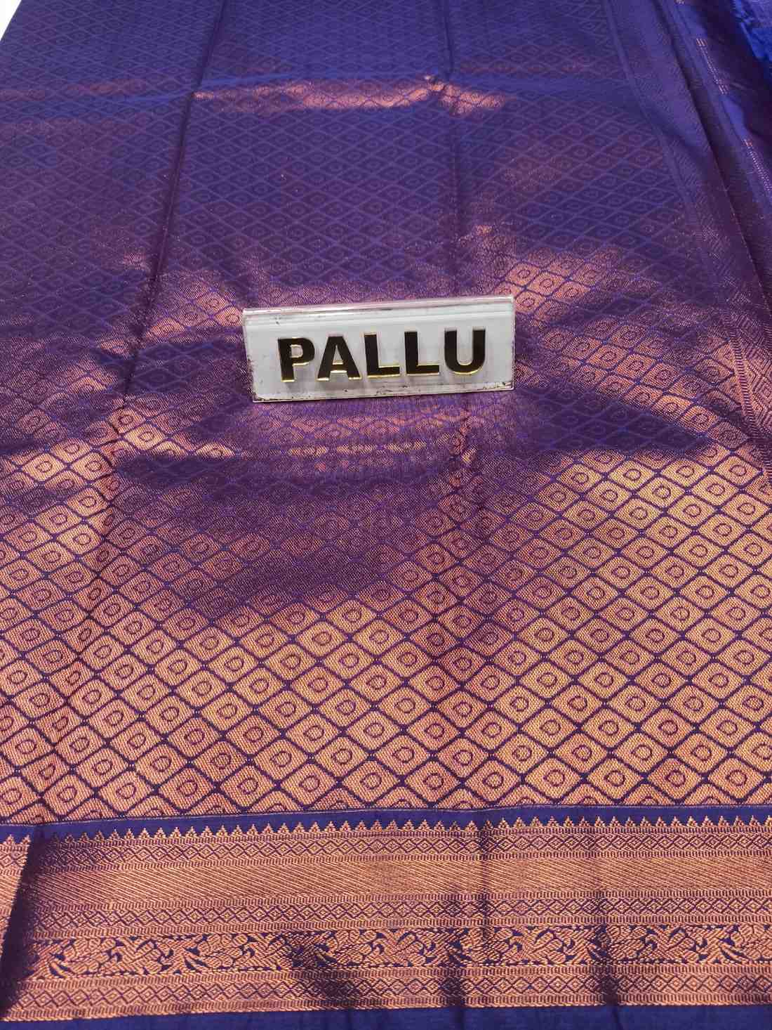 Purple and brown patterned fabric with a 'PALLU' label.