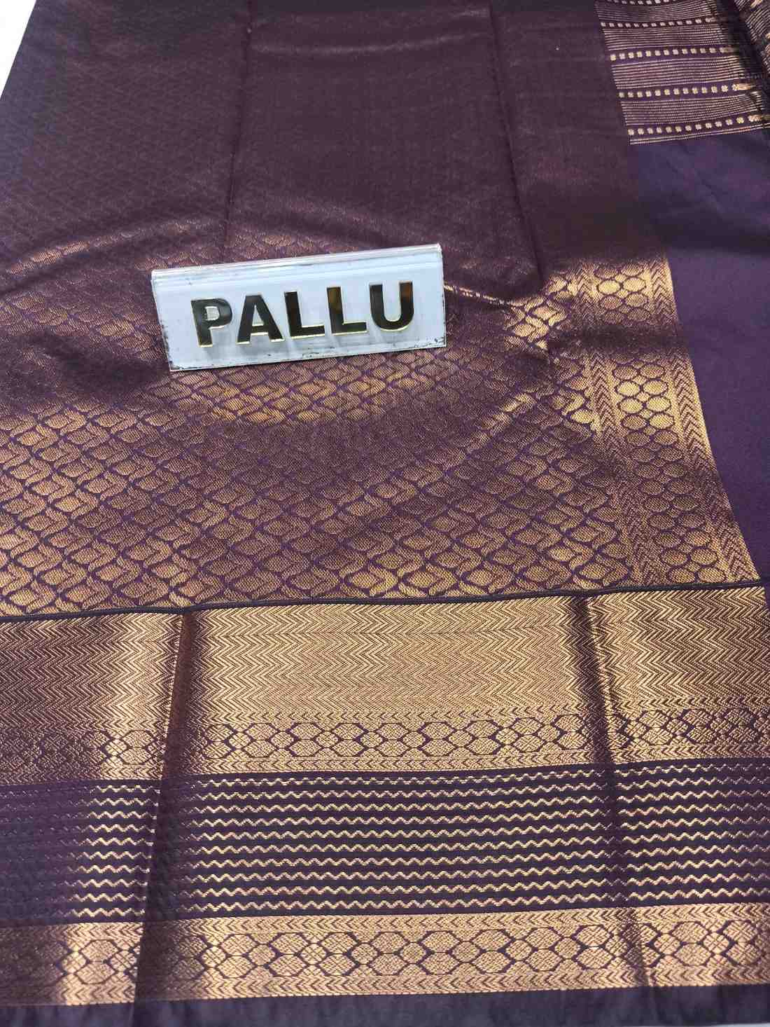 Purple and gold patterned fabric with a label reading 'PALLU'.