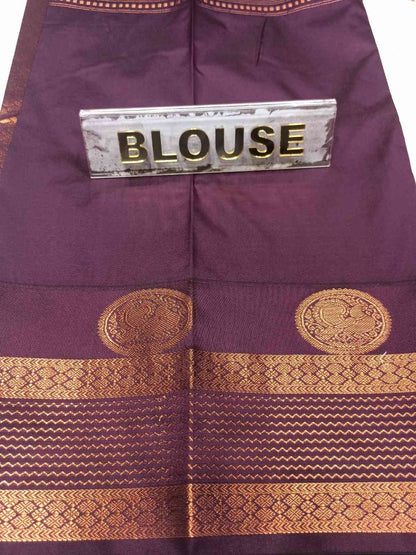Purple blouse with gold patterns and a label on a white background