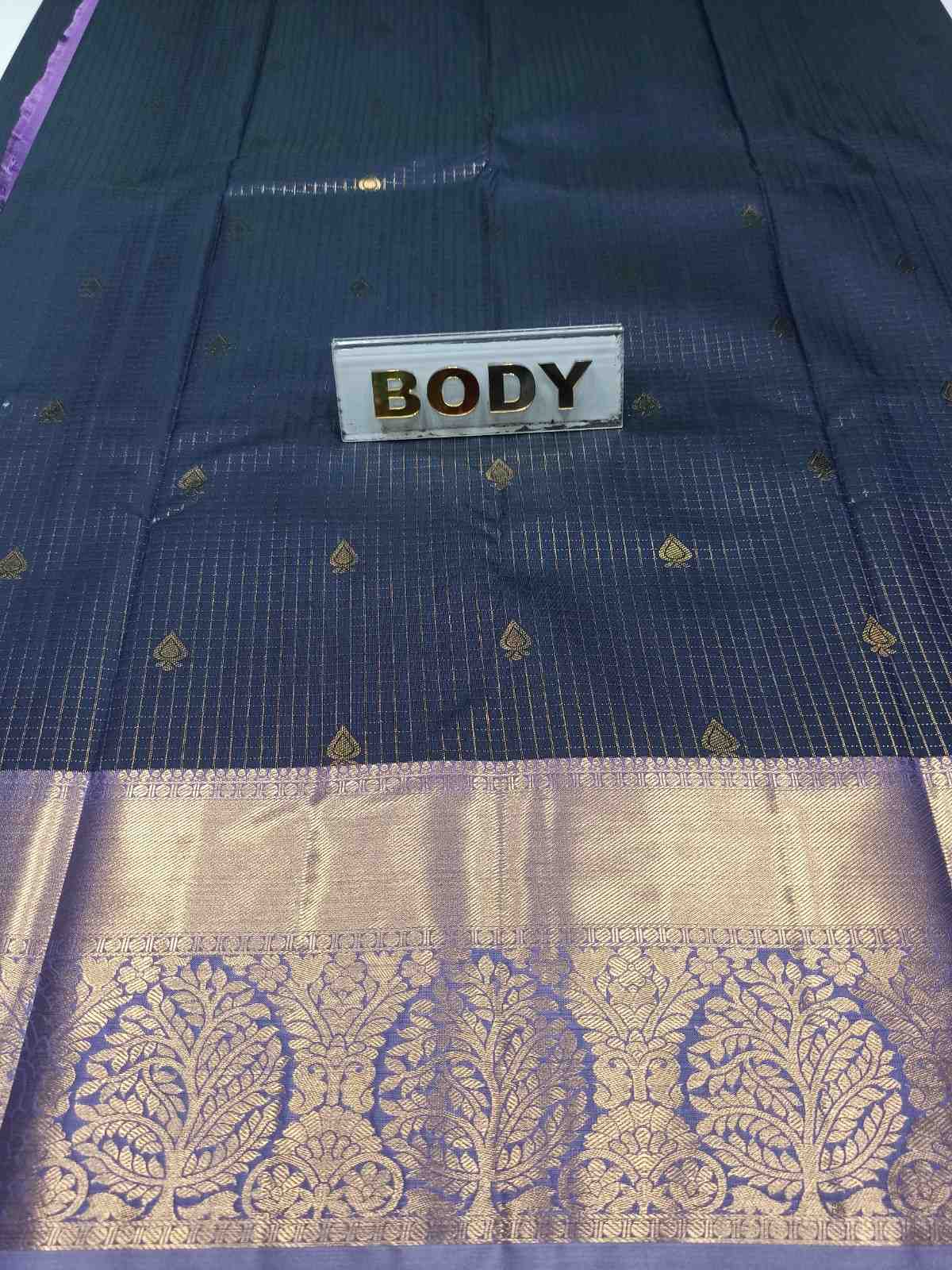 Navy blue saree with gold patterns and 'BODY' label.