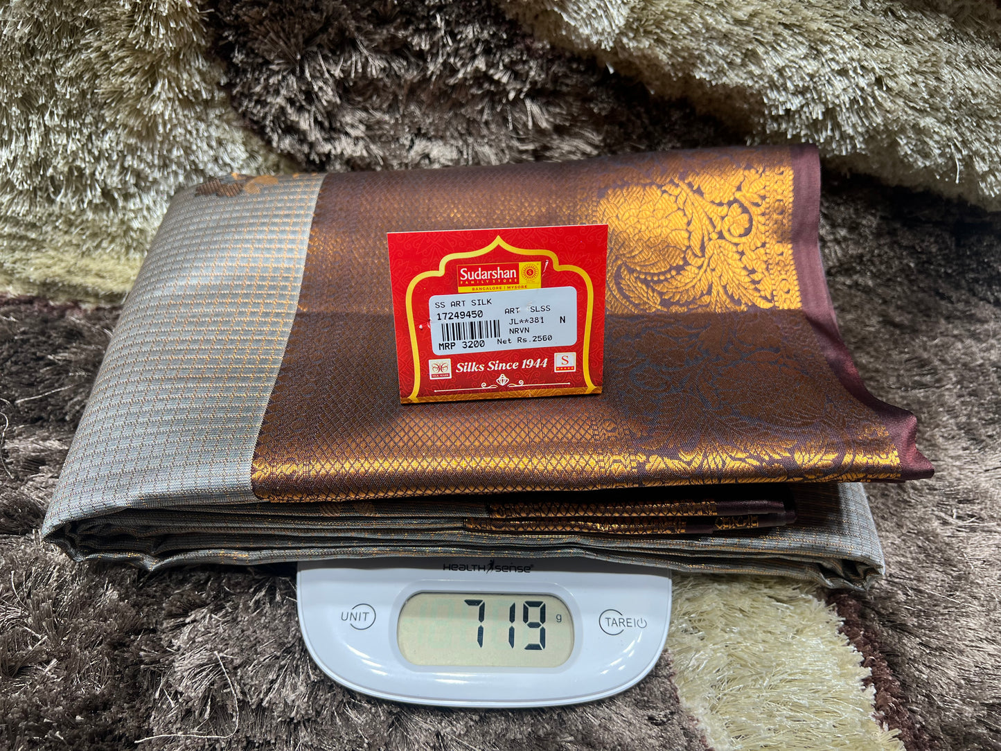 Fabric with a label on a digital scale against a textured background