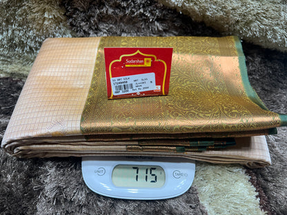 Gold fabric with a label on a digital scale showing weight
