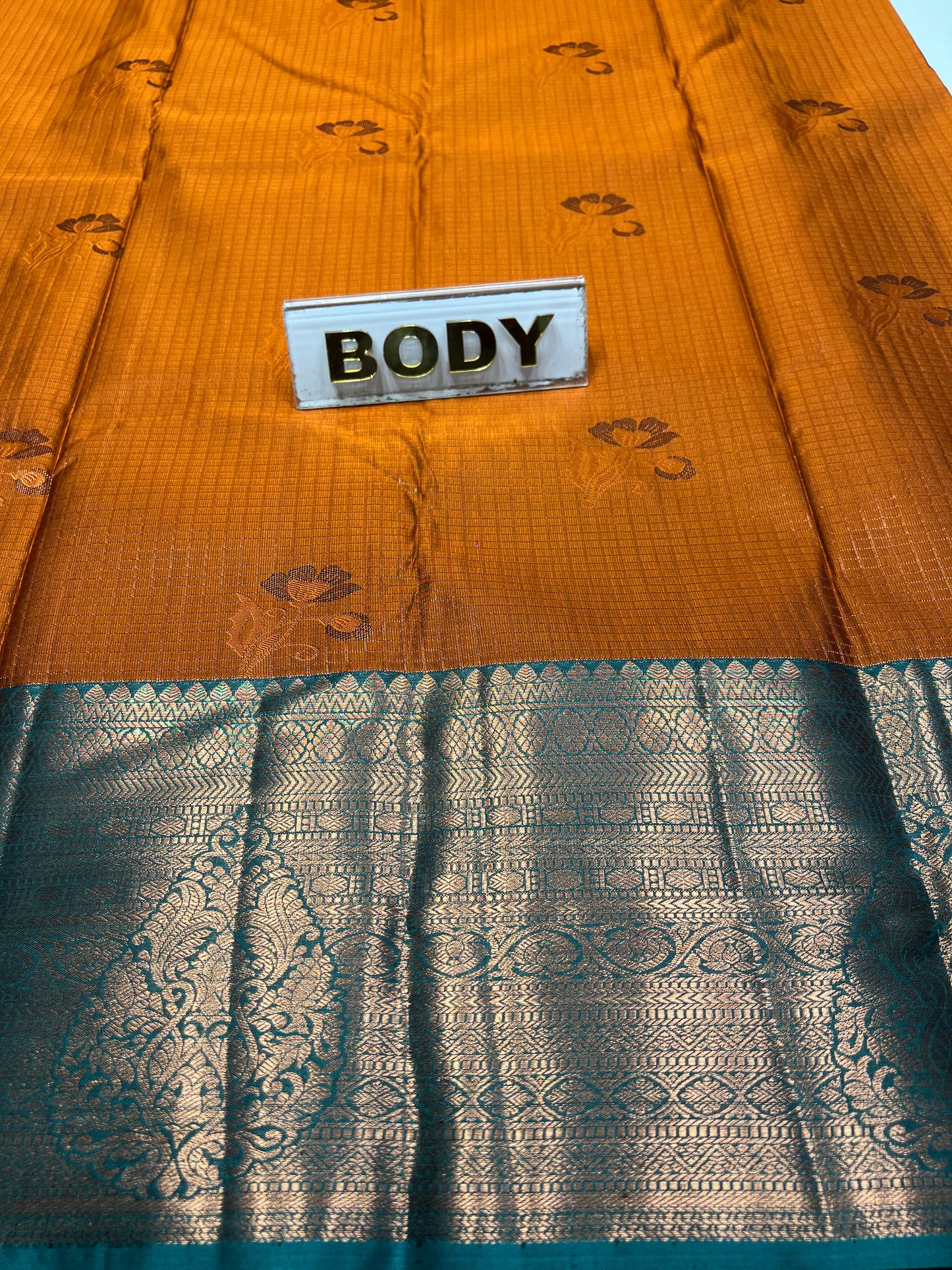 Two fabric samples, one orange and one blue with intricate patterns, labeled 'BODY'.