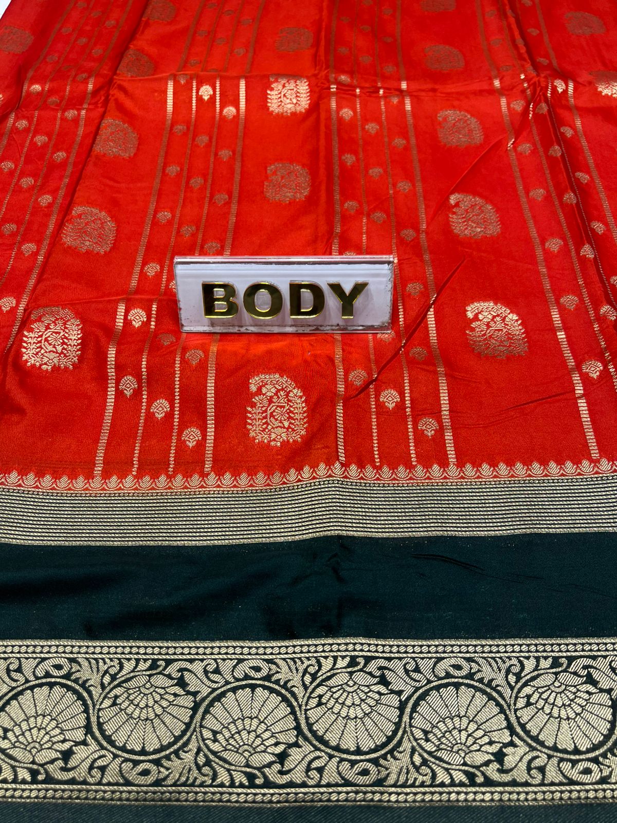 Red and black patterned fabric with a label labeled 'BODY'.