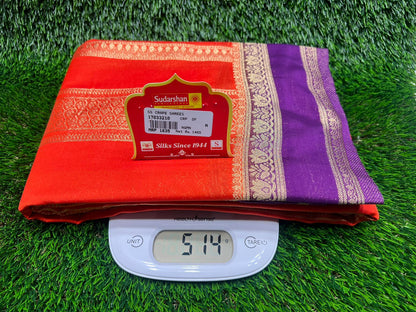 Red and purple fabric with a digital weight scale on grass