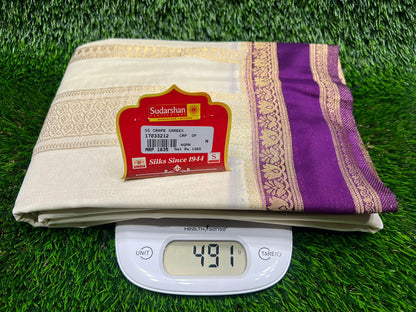 Digital scale displaying weight on a folded fabric with a brand label on a grass-like background