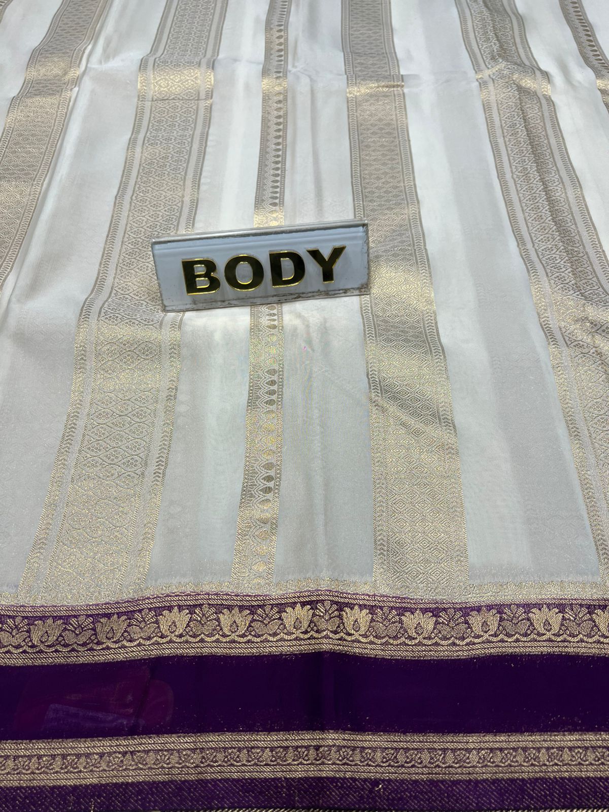 Textile with a label labeled 'BODY' on a patterned fabric background