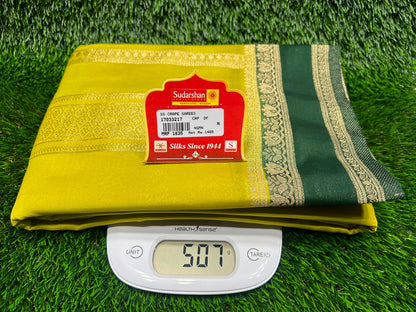 Yellow and green fabric with a label on a grassy background
