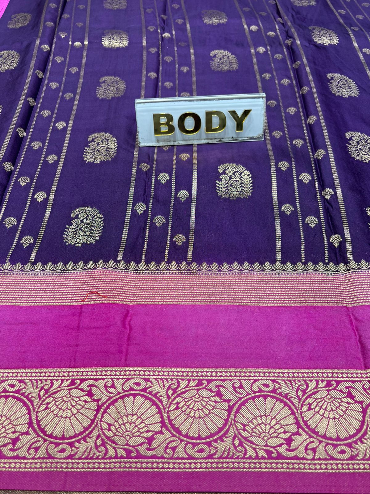 Purple saree with pink border and gold patterns, labeled 'BODY'.