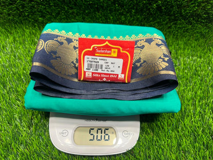 Green mat with a blue and gold border and a red label on a green grass background