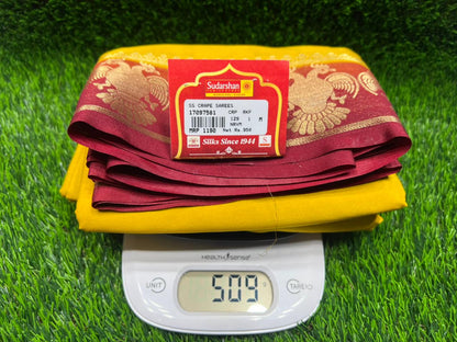 Yellow and red fabric with a digital scale on a green grass-like surface