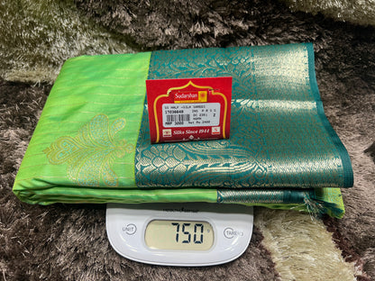 Green and gold fabric with a label on a digital scale