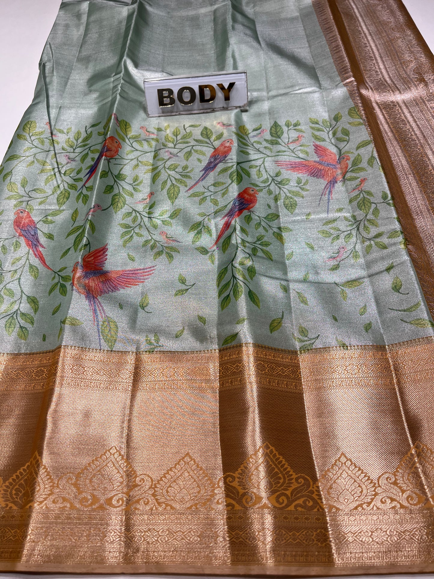 Saree with floral design and gold border, labeled 'BODY'.