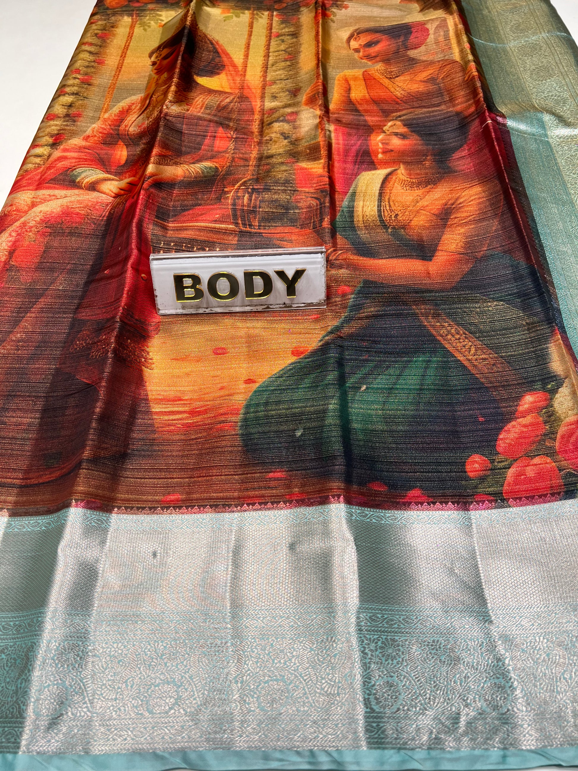 Sarong with a printed design and 'BODY' label on a white background