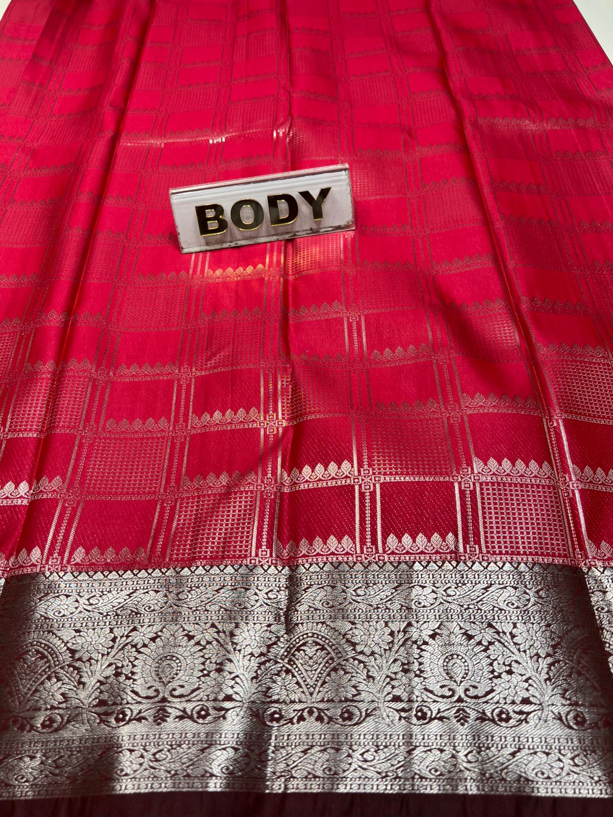 Red fabric with a patterned border and a label labeled 'BODY'.