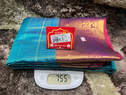 Folded sarees with a scale showing weight on a textured surface