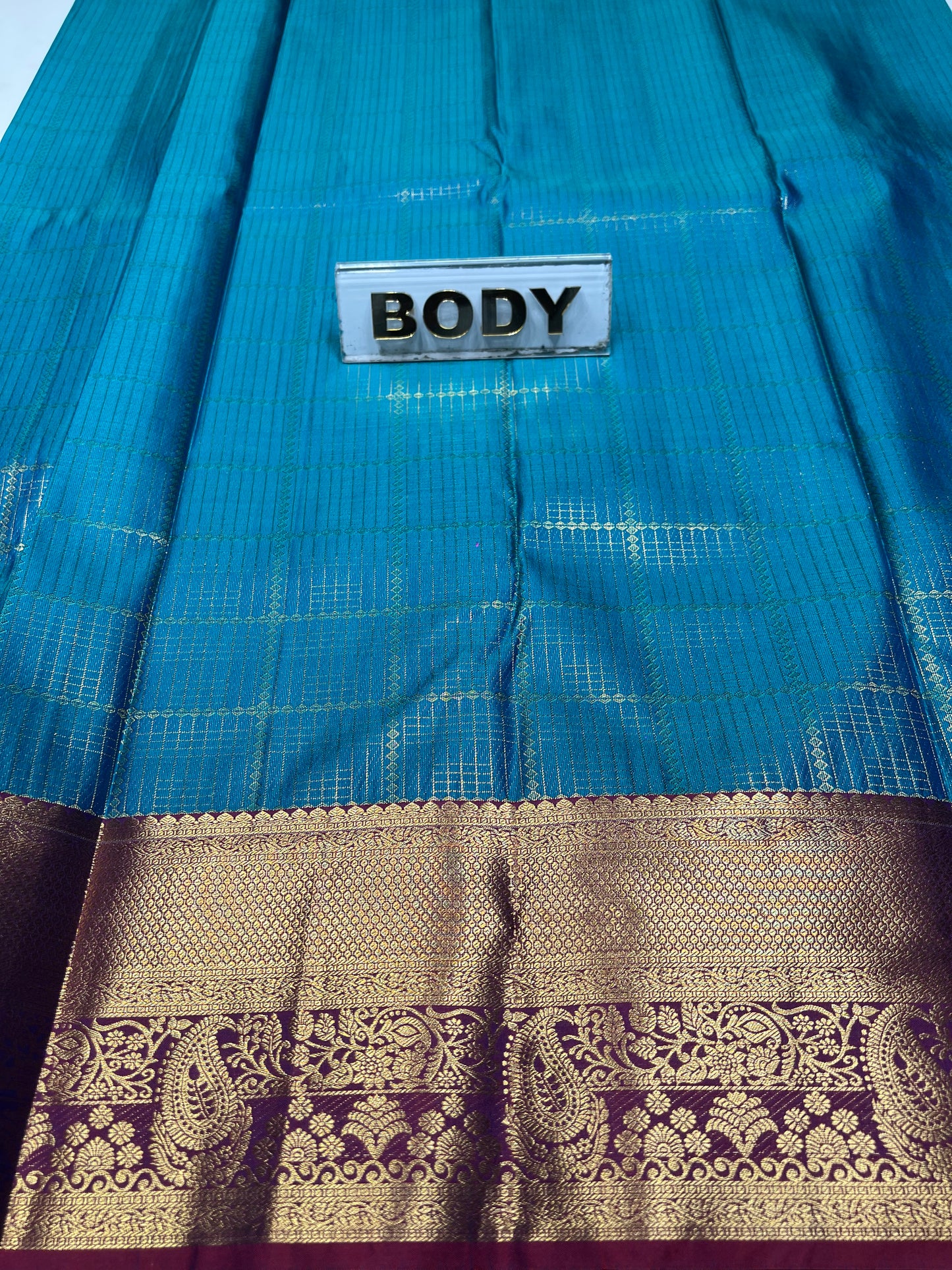 Blue saree with a decorative border and 'BODY' label.