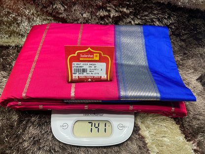 Pink and blue saree with a weight scale displaying 741 grams on a textured surface.