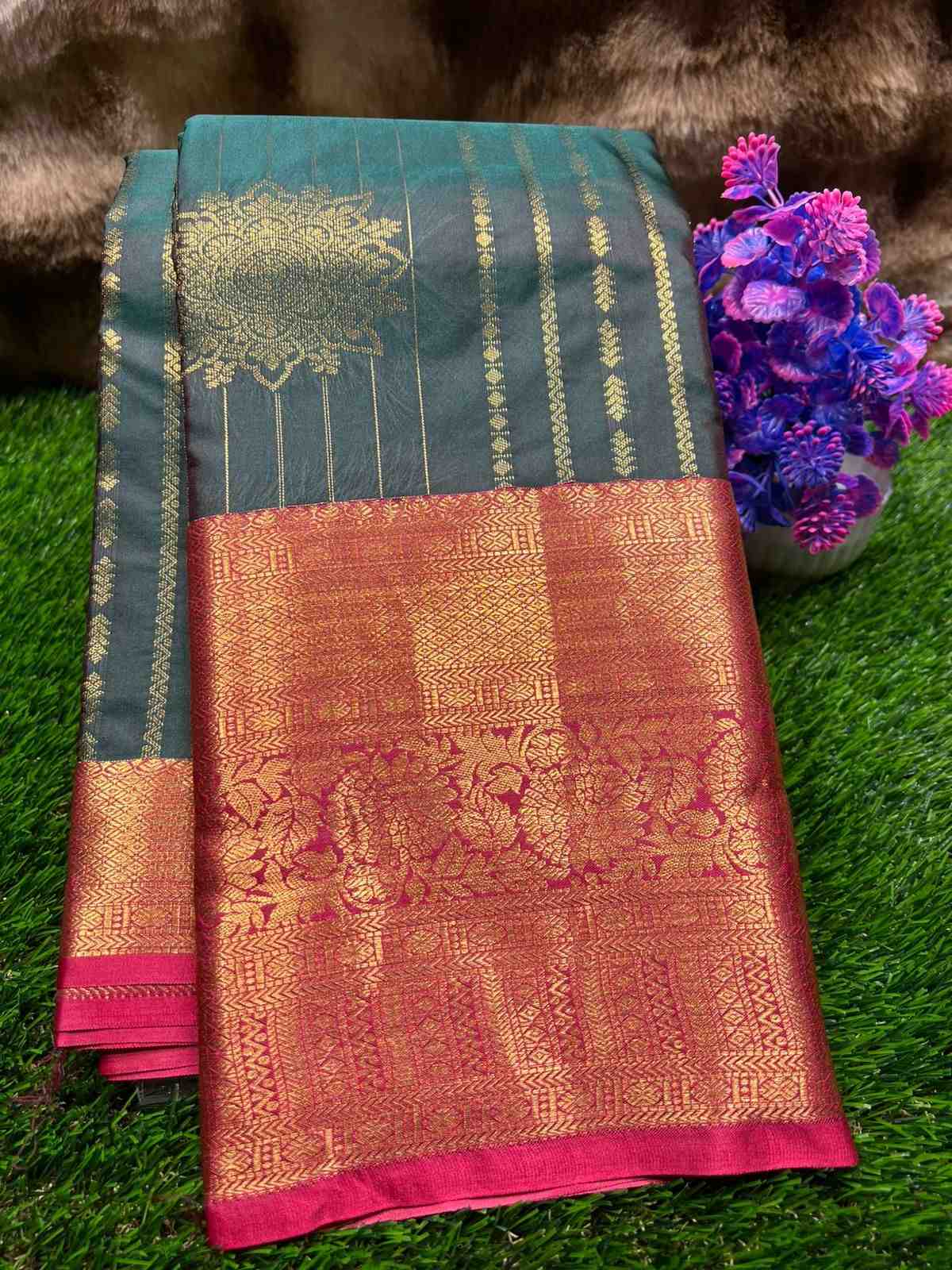 Traditional saree with intricate patterns on a green grass background