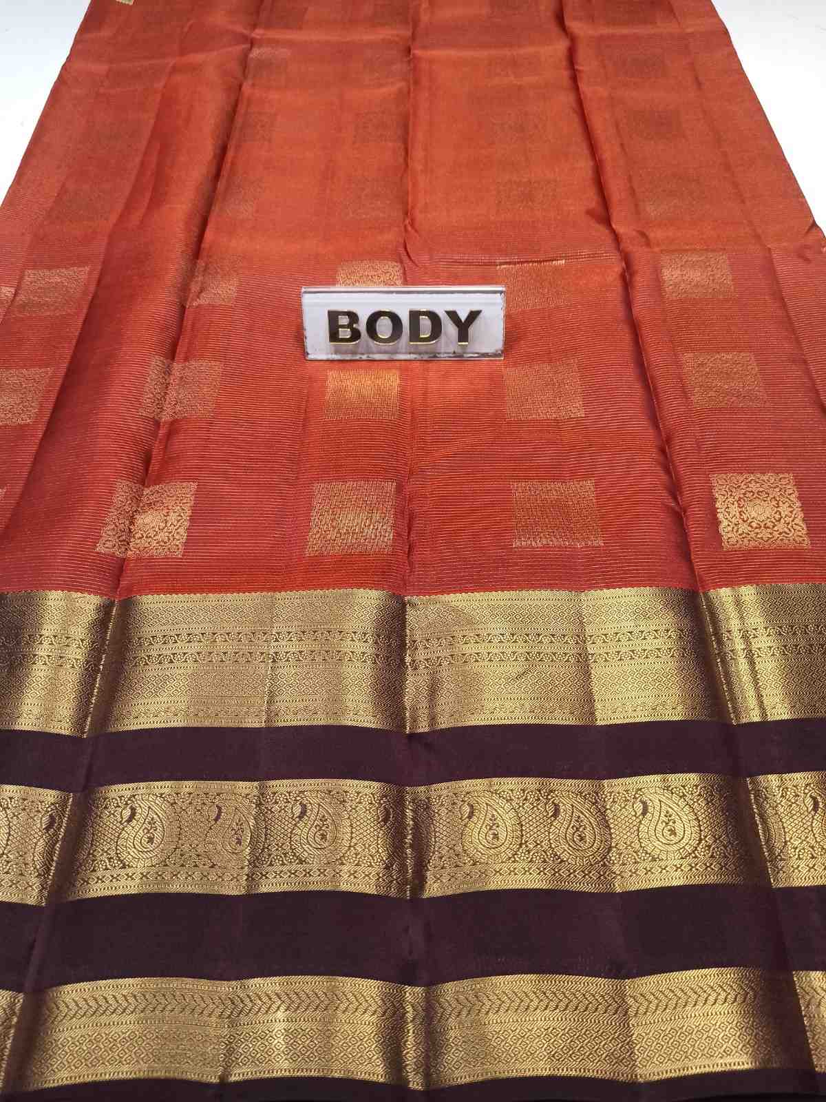 Red and gold traditional fabric with 'BODY' label