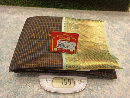 Gold foil sheet, Sadaam brand label, and digital scale on a textured surface