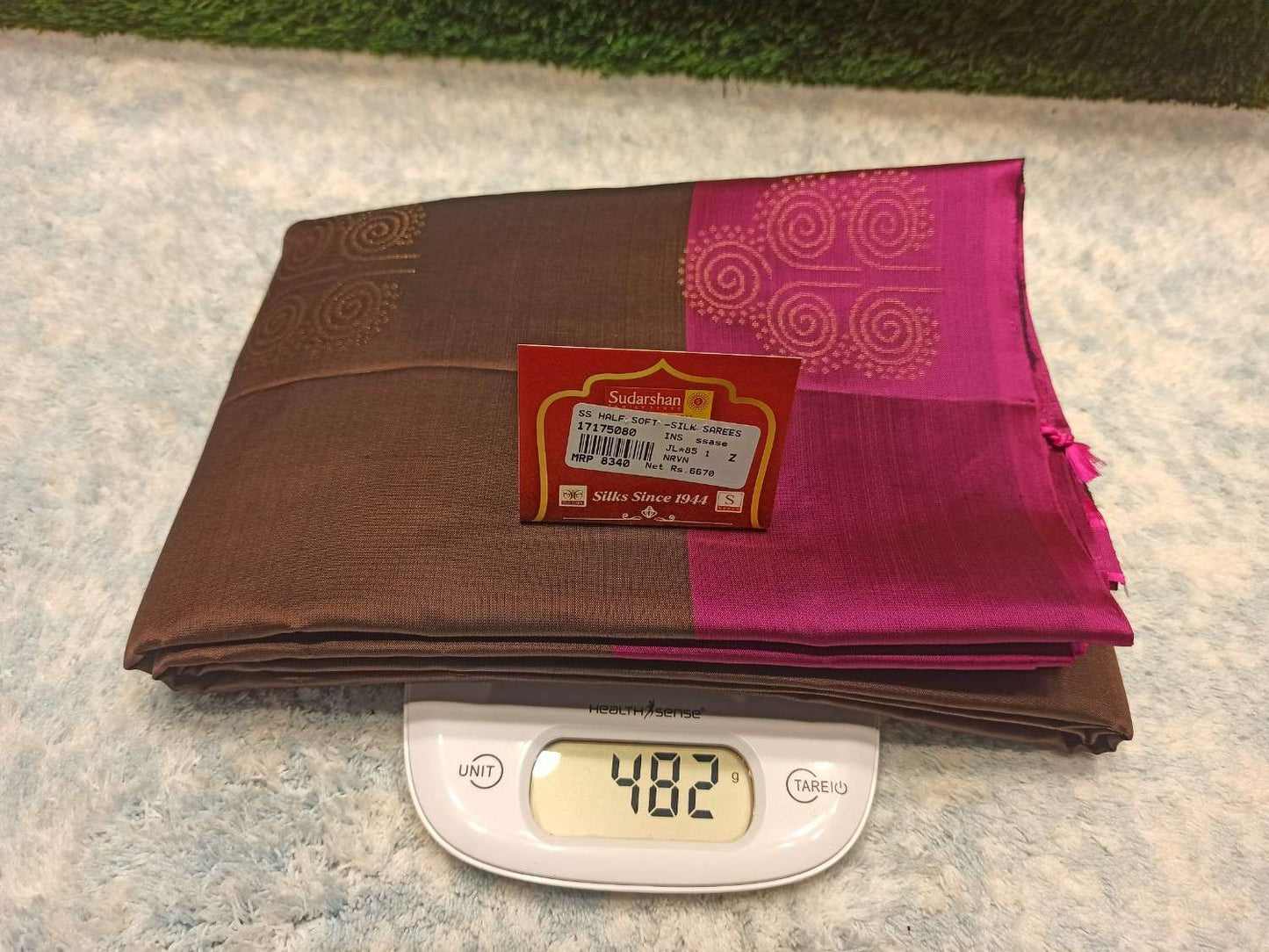 Brown and pink fabric with a label on a digital scale