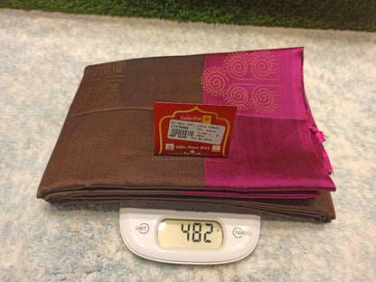 Brown and pink fabric with a label on a digital scale