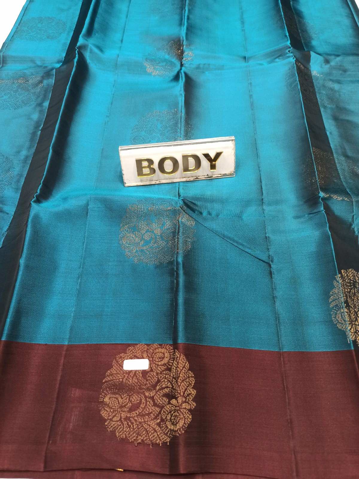 Teal and brown fabric with 'BODY' label