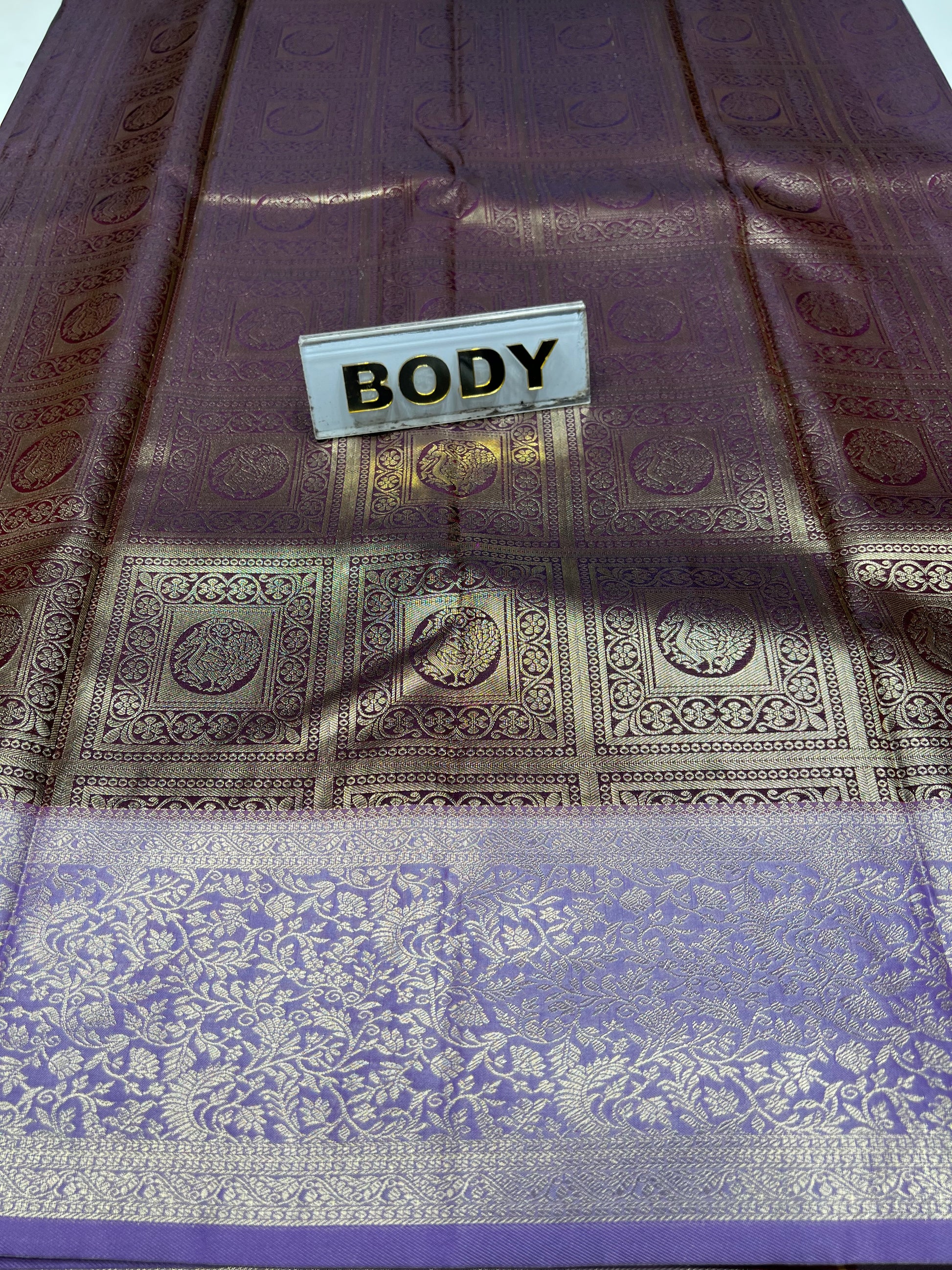 Decorative fabric with intricate patterns and a 'BODY' label.