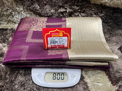 Two fabric swatches, one purple and one gold, with a Sushika label on a digital scale.