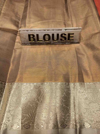 Brown blouse with a label indicating 'BLOUSE' on a matching fabric background.