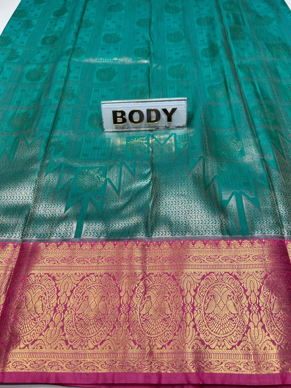 Green saree with a pink border and 'BODY' label.