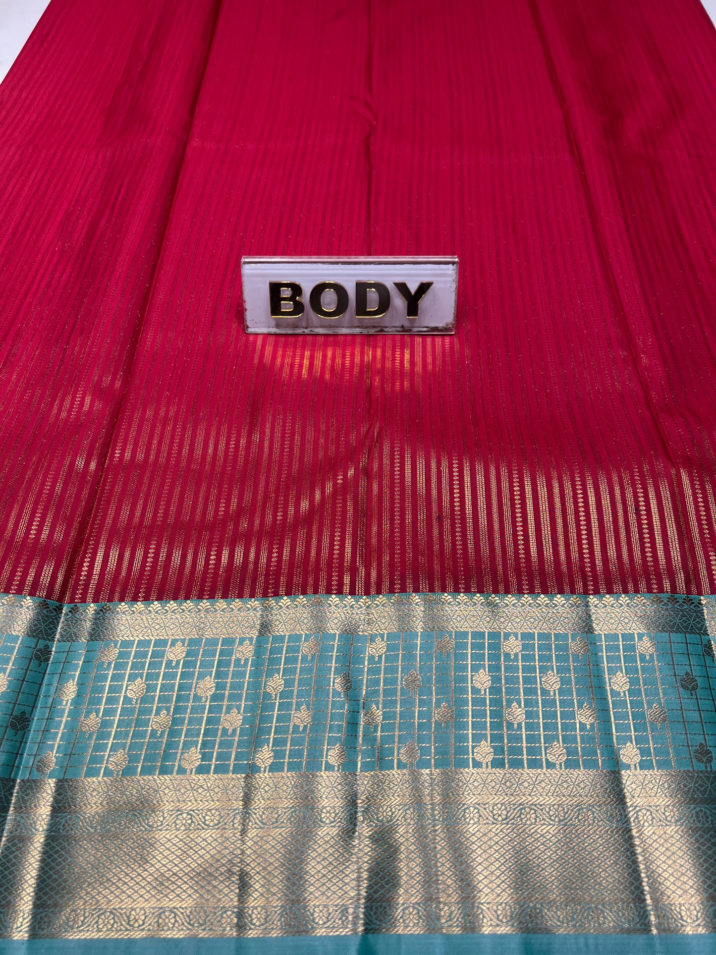Red fabric with a 'BODY' label on the left and a patterned blue and silver fabric on the right.