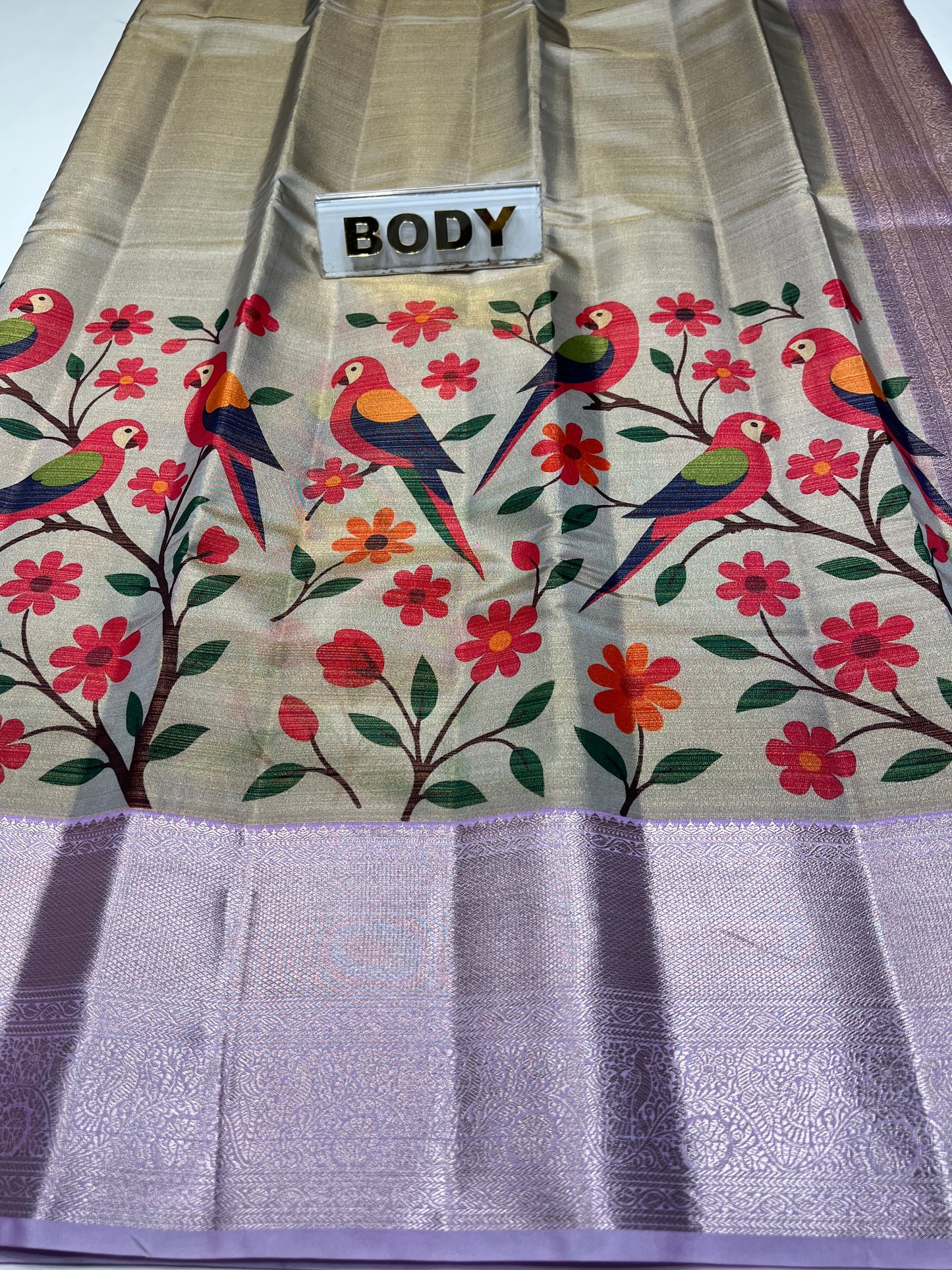 Saree with bird and floral pattern on a plain background
