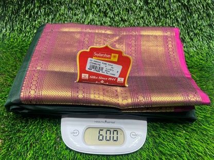 Folded fabric with a brand label on a digital scale against a grass background