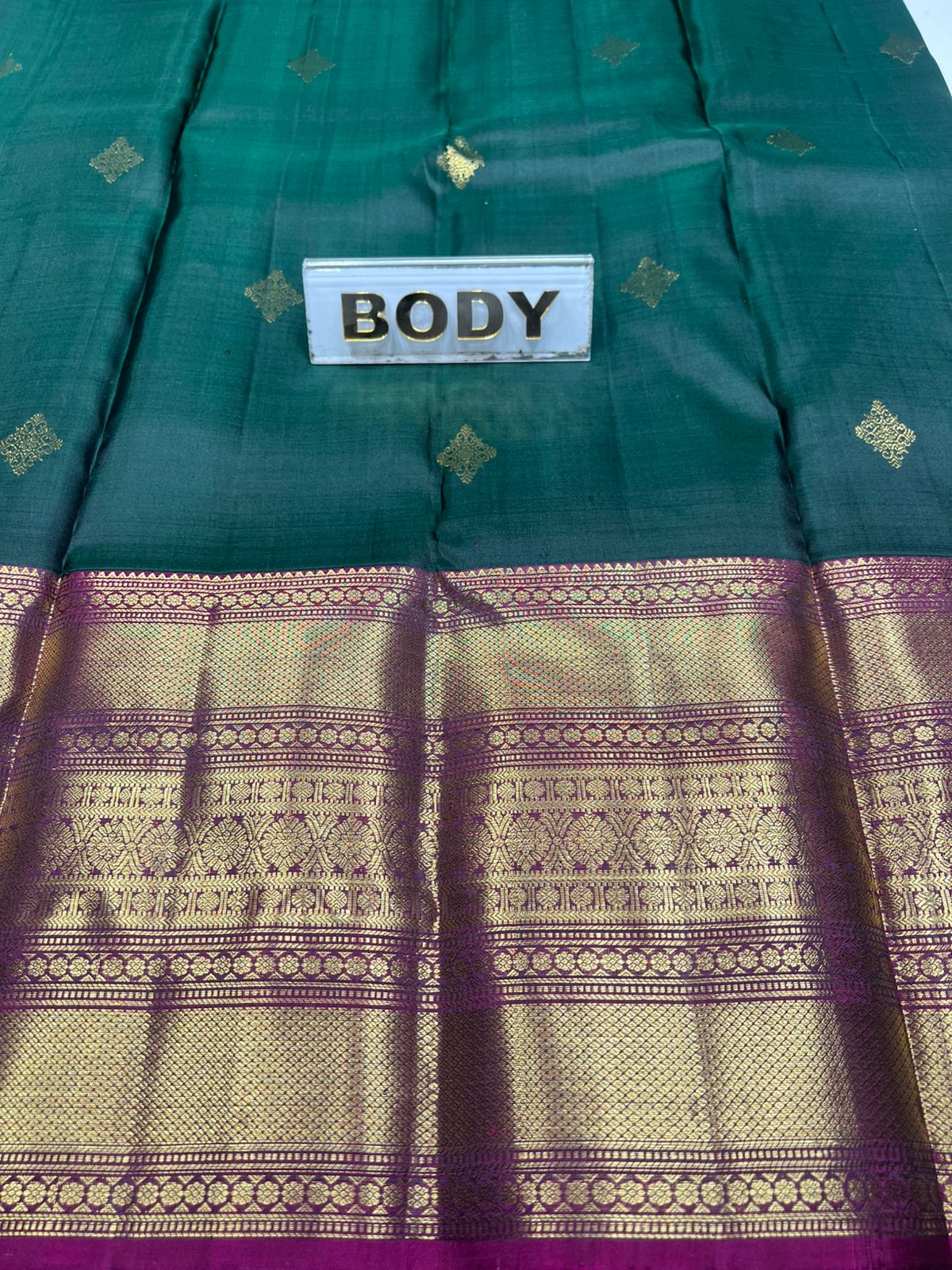 Green and purple traditional fabric with 'BODY' label