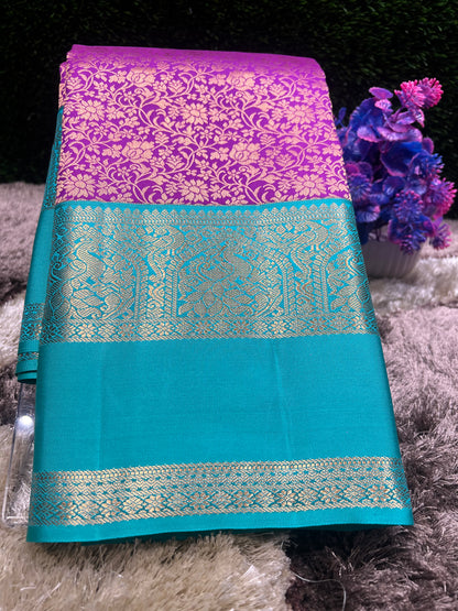 Teal and purple fabric with intricate patterns on a textured surface