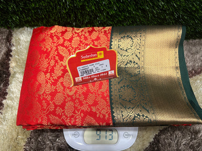 Red and gold fabric with a label on a textured surface