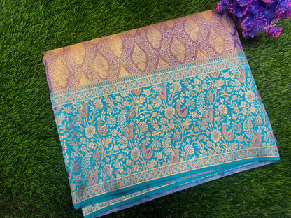 Blue and gold patterned fabric on a green grass background