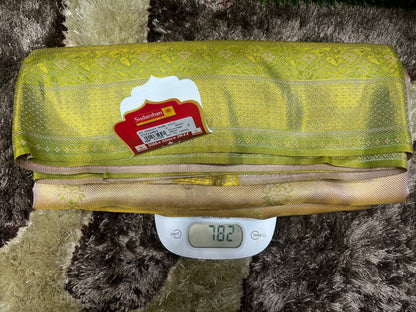 Green fabric with a tag on a digital scale against a textured brown background