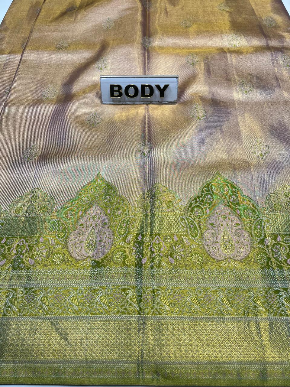 Textile with green and brown patterns and a label labeled 'BODY'.