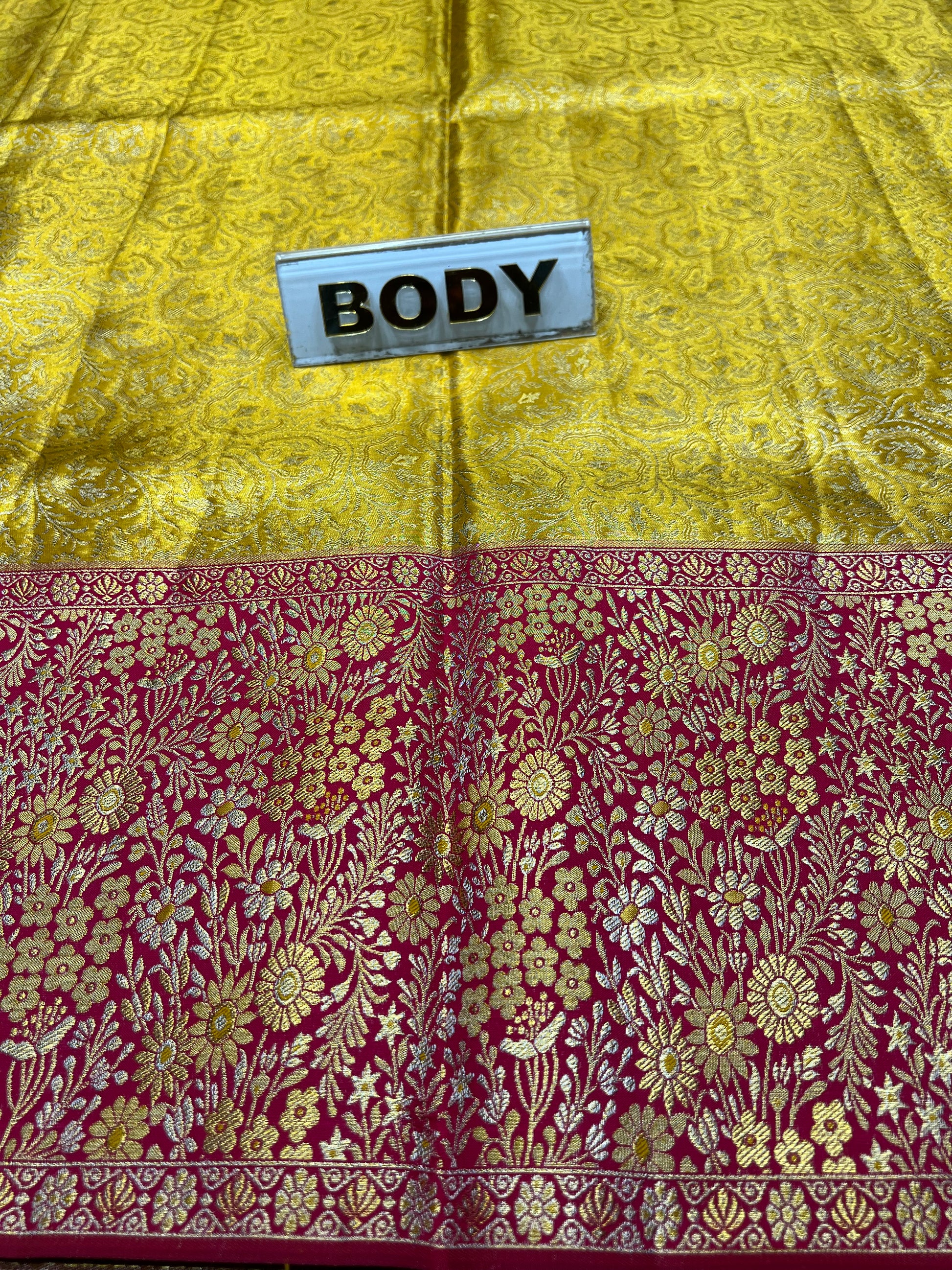 Two fabric samples, one yellow and one maroon with floral patterns, labeled 'BODY' and 'SASH'.