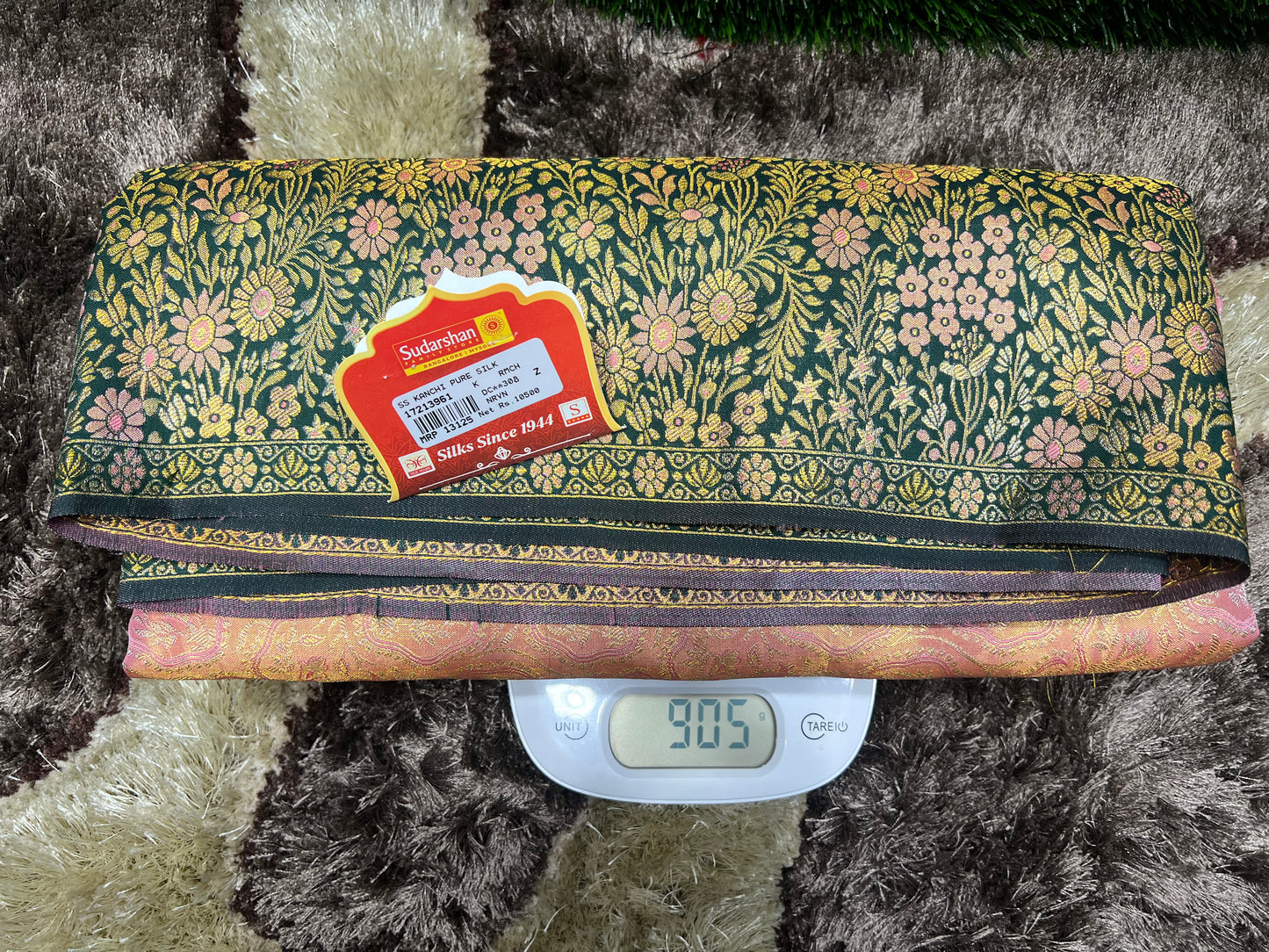 Fabric roll with a floral pattern on a digital scale