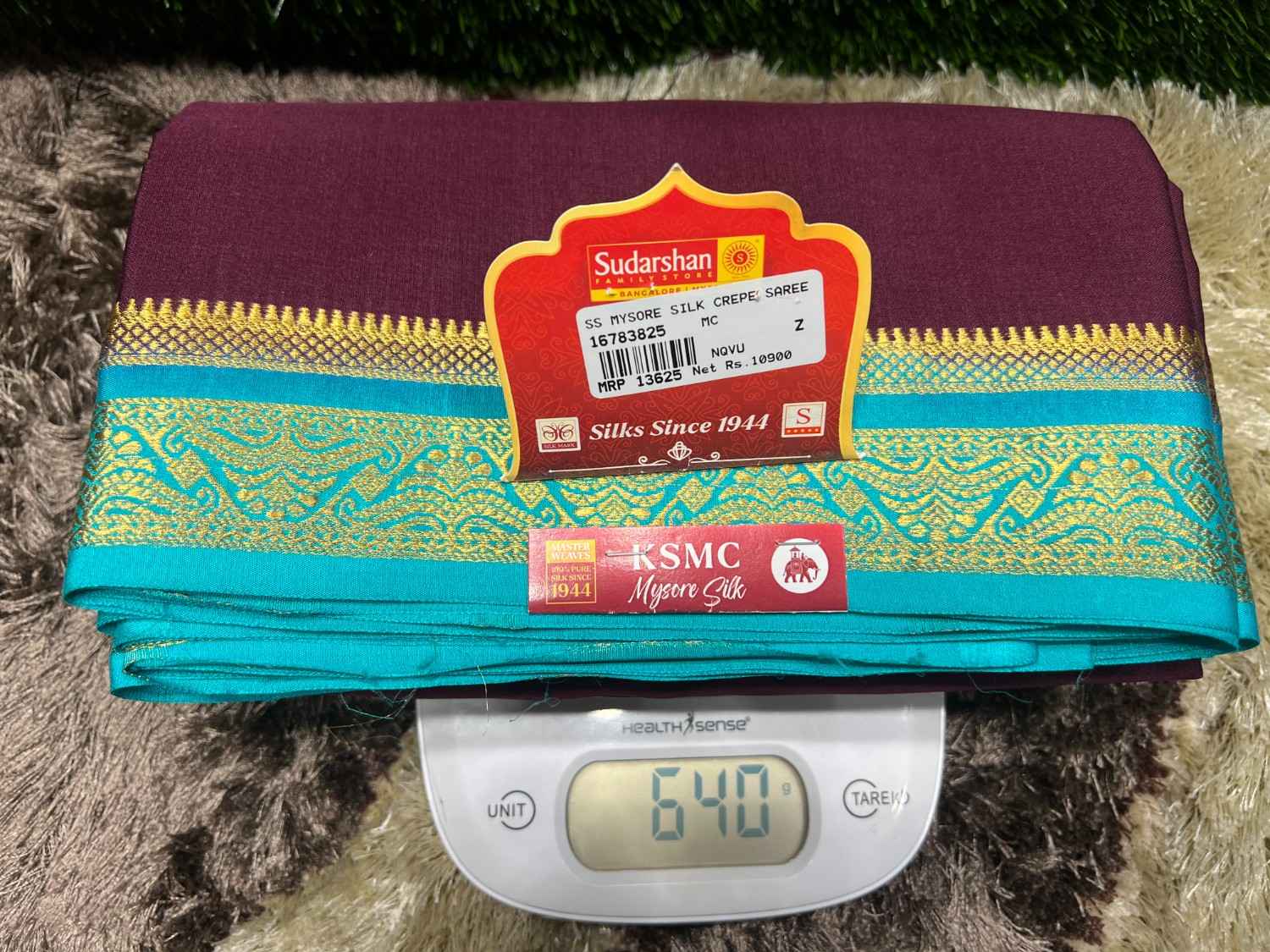 Saree with a brand label on a digital scale