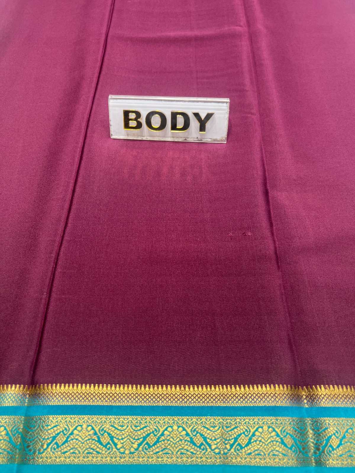 Purple fabric with gold and blue border and 'BODY' label.