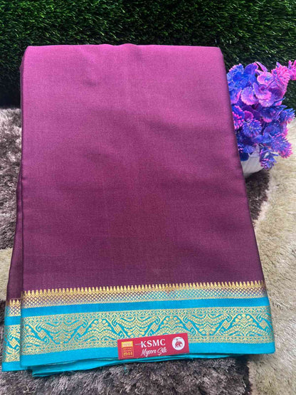 Purple saree with a blue border featuring KSMC logo on a textured surface.