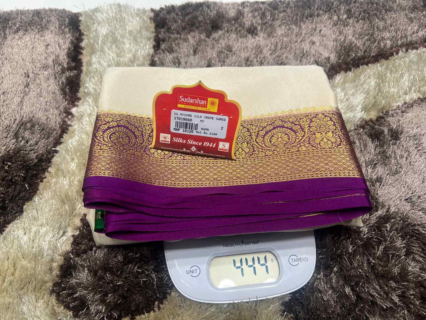 Folded fabric with a label on top of a digital scale on a textured surface