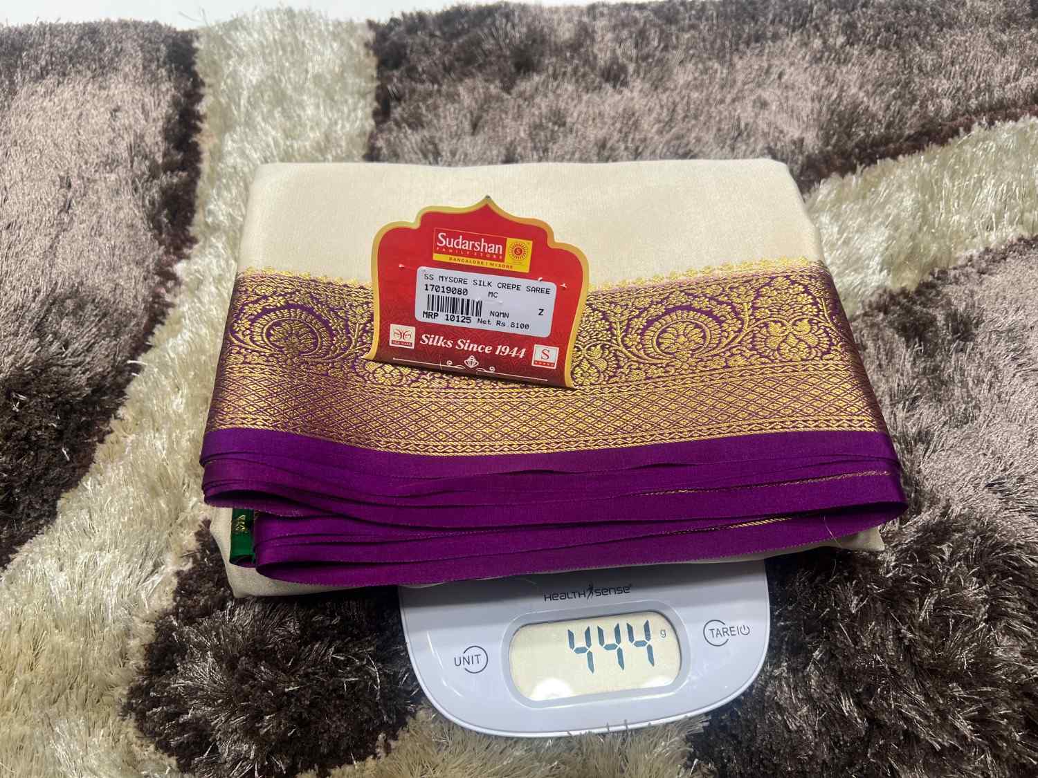 Folded fabric with a label on top of a digital scale on a textured surface