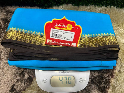 Blue saree with a brand label on a digital scale