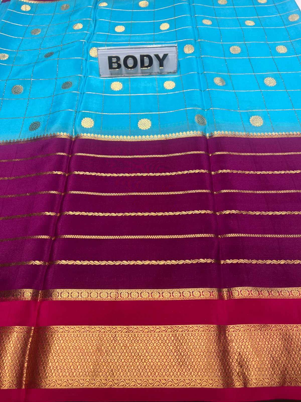 Blue and purple saree with gold accents and a 'BODY' label.